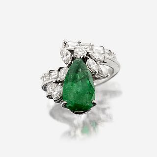 An emerald, diamond, and fourteen karat white gold ring