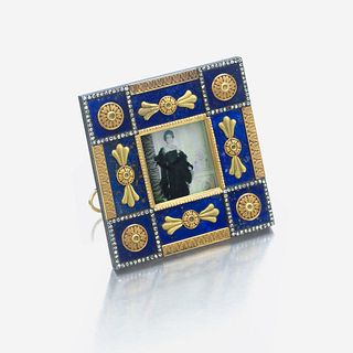 A bicolored gold-mounted lapis lazuli and diamond miniature picture frame, Fabergé marked Fabergé, workmaster's mark of Henrik Wigström, c. 1890