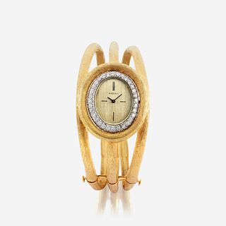 A diamond and eighteen karat gold bangle watch