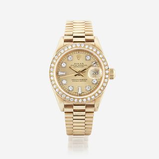 An eighteen karat gold and diamond, automatic, bracelet wristwatch with date