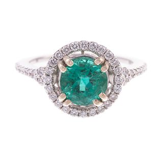 An Emerald and Diamond Halo Ring in 14K