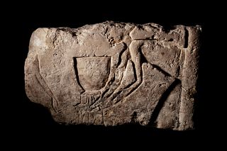 An Egyptian Limestone Relief Fragment  
Height 9 x width 14 1/2 inches.