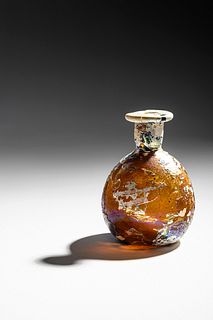 A Roman Amber Glass Flask
Height 3 3/4 inches. 