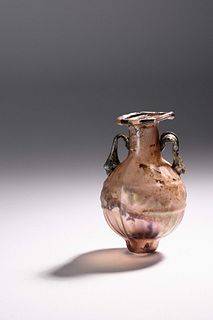 A Sidonian Mold-Blown Aubergine Glass Flask with Tendril Scrolls  
Height 2 1/2 inches. 