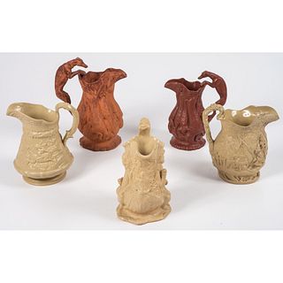 Five Molded Stoneware Pitchers