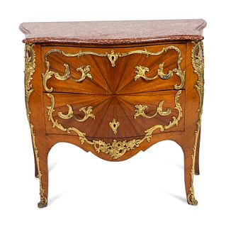 A Louis XV Style Bombe Commode with Sunburst Veneer and Gilt Metal Mounts
Height 35 x width 38 x depth 19 inches.