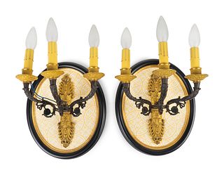 A Pair of French Empire Style Bronze and Gilt Bronze Three Light Wall Sconces
Height 12 1/2 x width 9 1/2 inches.
