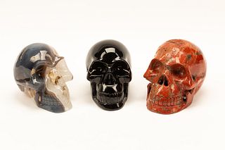 A Set of Three Obsidian, Agate and Red Jasper Skulls
Height of first skull 6 1/2 inches.
