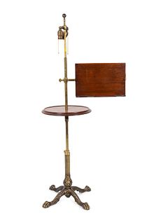 An English Brass Adjustable Floor Lamp with Mahogany Table and Adjustable Book Shelf
Height 54 x diameter 14 3/4 inches.
