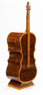 A Burlwood Veneered Cello-Form Cabinet
Height 61 x width 20 x depth 13 1/2 inches.