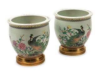 A Pair of Chinese Porcelain Jardinieres with Gilt Bronze Bases
Height 16 1/2 x diameter 16 inches.