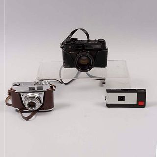 Lote de 3 cámaras fotográficas. Siglo XX. Elaboradas en metal, baquelita y material sintético. Marca Yashica y Kodak.
