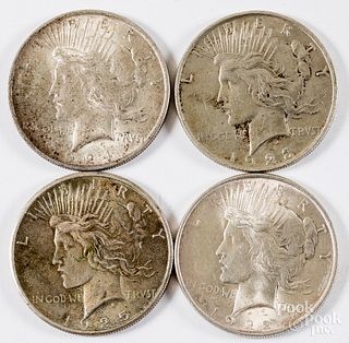 Four Peace silver dollars