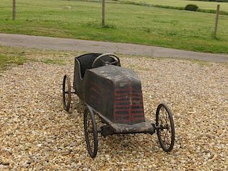 A rare early 20thC childs' pedal-car c1920; of painted plywood panels on wood & metal frame mounted