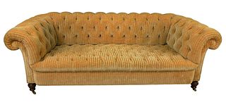 Tufted Upholstered Sofa, on brass castors, length 87 inches.