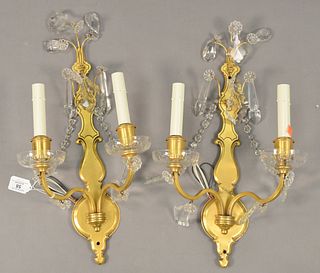 Pair of Brass and Rock Crystal Two Light Wall Sconces, having crystal drops and floral forms, height 11 inches, width 19 1/2 inches.