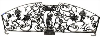 Cast Iron Figural Fire Fender, having scrolling acanthus leaves with iron worker in center, height 16 1/2 inches, length 48 inches.