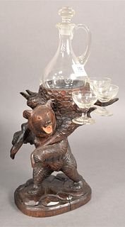 Carved Black Forest Bear Decanter Set, along with five glasses, height 16 inches, width 8 inches.