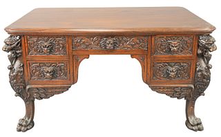 R.J. Horner Mahogany Winged Griffin Carved Desk, having lion face drawers and faux drawer on reverse, all set on large claw feet, height 30 inches, to