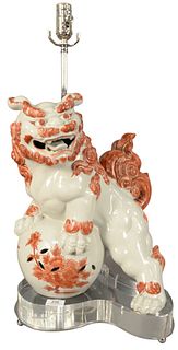 Porcelain Iron Red and White Glazed Foo Dog Form Lamp, mounted on Lucite base, height 27 inches, width 14 inches.