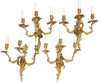 Set of Four Gilt Bronze Sconces, each having three lights, height 17 inches, width 18 1/2 inches.