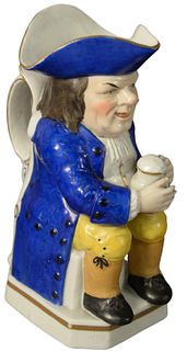 Staffordshire Ralph Wood Toby Jug, seated having blue hat and jacket holding a pitcher, height 8 1/4 inches.