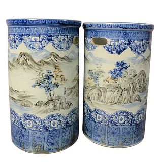 Pair of Chinese Blue and White Umbrella Holders, each having a mountainous village scene, unmarked, height 18 inches, width 11 inches.