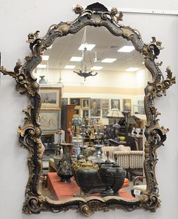 Venetian Black and Gilt Mirror, having three dimensional carving, 19th century, height 50 inches, width 36 inches.