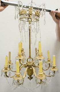 French Empire Gilt Bronze and Crystal Chandelier, having 12 lights and drop crystals, width 25 inches, length 30 inches.