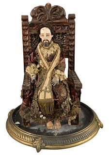 18th Century Spanish Colonial Saint, seated in glass dome, height 19 inches.