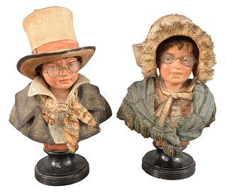 Pair of German Terracotta Busts, to include a female figure having a bonnett, and the male having a top hat and jacket, copy written in German on the 