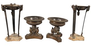 Two Pairs of Bronze Grand Tour Urns, one pair having mounted ram heads and ending in hoofed feet, mounted on marble bases; along with a pair ending in