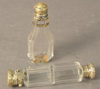 Two Clear Glass Perfume Bottles, one having double sides with silver covers; the other having silver hinged top and silver base, tallest height 5 inch