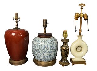 Four Chinese Porcelain Table Lamps, each mounted on brass bases, to include one blue and white; one oxblood; one white glazed with a hardstone center;