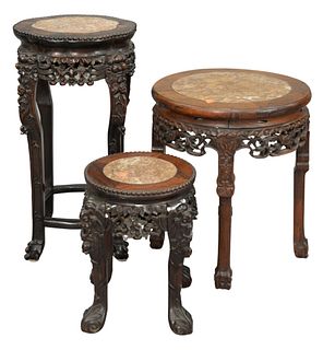 Three Chinese Hardwood Stands, all having inset rouge marble, tallest 25 inches, diameter 13 inches.