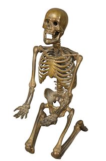 David Dempsey (American, 20th century), kneeling skeleton, bronze with brown patina, initialed and dated on the hip: DWD '89; height 7 3/4 inches.
