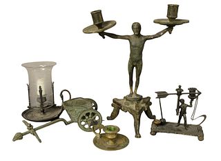 Group of Five Bronze Grand Tour Items to include a bronze nude male figure candelabra; a miniature bronze gladiator chariot; a brass candlestick; an e