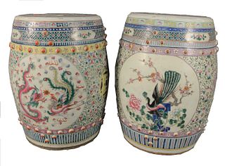 Two Chinese Famille Rose Garden Seats, one having painted dragon panels; the other painted with peacock and floral decoration, height 18 1/2 inches, d