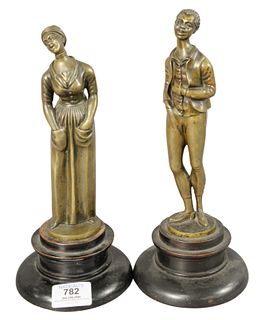 Pair of African American Bronze Figures, depicting a man and woman dressed in 19th century clothing, both raised on wooden bases, height of both 10 3/