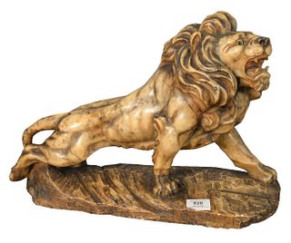 Carved Alabaster Lion, on matching base, having glass eyes, height 13 inches, length 18 inches.