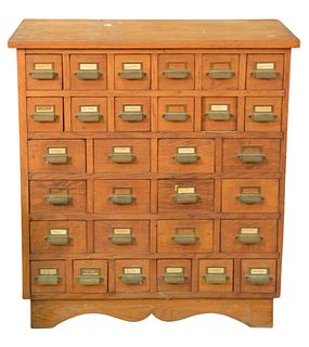 Two Piece Lot, to include oak file cabinet having 30 drawers, height 31 inches, top 14" x 31"; along with an oak two door medicine cabinet.