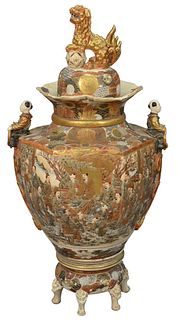 A Large Japanese Satsuma Palace Urn, on stand with cover topped with gilt foo lion, height 51 inches, width 24 inches.