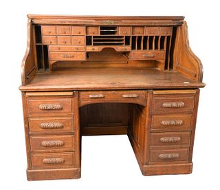 J.F. Dietz Company Oak S-Roll Top Desk, having quarter sawn raised panel with carved pulls and sixteen drawer interior, signed J.F. Dietz Co., Cincina