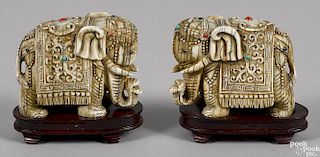 Pair of Asian carved ivory elephants, ca. 1900, with gilt highlights and hardstone mounts