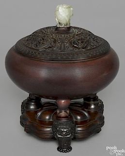 Chinese Qing dynasty iron red glaze censer, 18th c., with a carved hardwood cover and stand