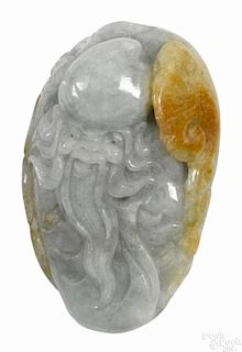 Chinese pale celadon and russet jade boulder, carved with a scholar's face, 3 3/4'' h.