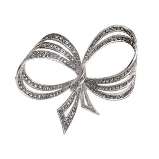 VIVIEN LEIGH. 
Three-turn bow brooch, 1950s. 
Silver metal decorated with marcasites.