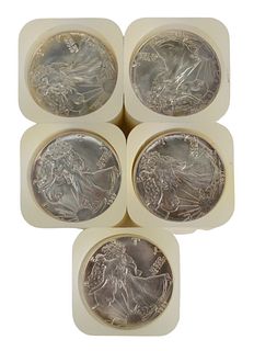 Five Rolls of Liberty Silver Eagles, one hundred 1987 coins total.
