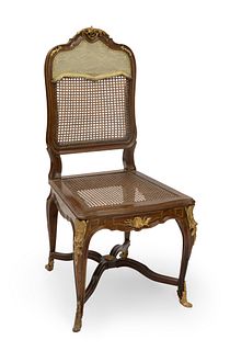 Luis XV style chair. France, 1860. Carved walnut wood, marquetry, grid and gilt bronze.