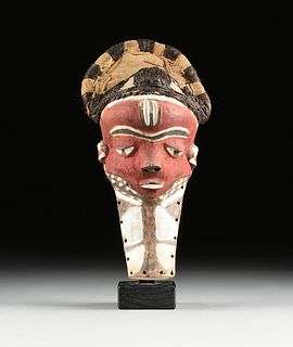 AN AFRICAN RED PAINTED MASK, PROBABLY BAULE PEOPLE, IVORY COAST, 20TH CENTURY,